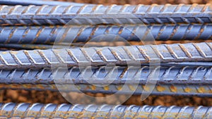 Steel rods or bars used to reinforce concrete for construction