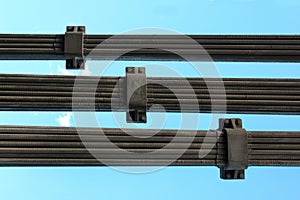 Steel ropes of cable-stayed bridge against blue sky background