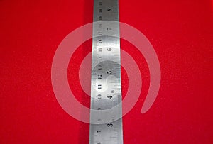 A Steel Ruler on Red Background