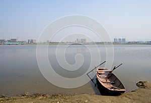 Steel sanitation boat at lakeside in sunny winter afternoon