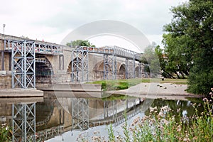 Steel scaffolding on historic stone bridge for renewal