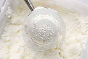 Steel scoop with tasty vanilla ice cream, closeup
