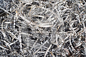 Steel scrap materials recycling. Aluminum chip waste after machining metal parts on a cnc lathe. Closeup twisted spiral steel