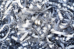 Steel scrap materials recycling. Aluminum chip waste after machining metal parts on a cnc lathe. Closeup twisted spiral steel