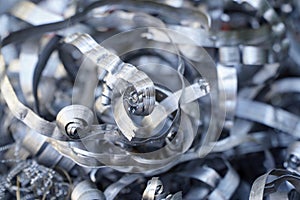 Steel scrap materials recycling. Aluminum chip waste after machining metal parts on a cnc lathe. Closeup twisted spiral steel