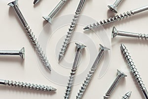 Steel screws, metal screw, screws on a white background view from the top.