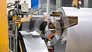 Steel sheet is wound on a roll on a special machine. Packed rolls of steel sheet, Cold rolled steel coils.