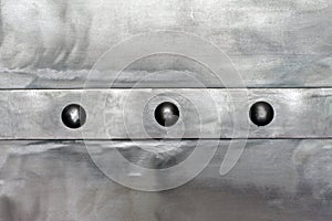 Steel shiny plate, with a horizontal strip, connected by rivets