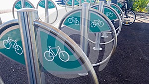 Steel silver green bicycle parking lot in city center