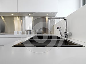 Steel sink and tap in the modern kitchen