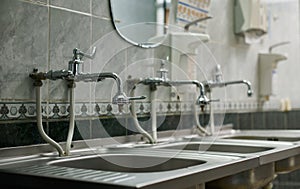 Steel sinks and taps of the preoperative room for the treatment of the surgeon`s hands