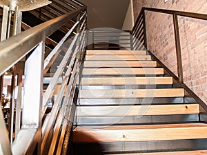 Steel staircase frame with wooden risers and steps photo