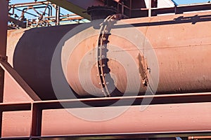 Steel staircase with a handrail winding upwards along a metal pipe