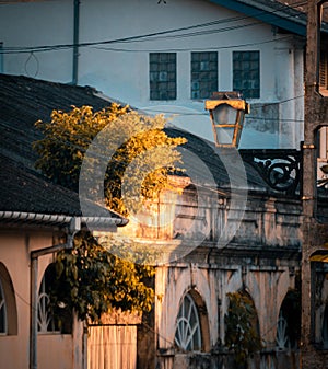 Steel street lamp in the Galle fort evening light hitting the background bushes landscape