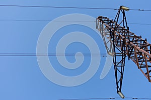Steel structure of a power line steel tower. Tower is against clear blue cloudless sky. Communication tower for power supply unit