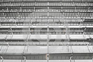 Steel structure roof of office building. Windows glass facade supported. Abstract architecture fragment background.