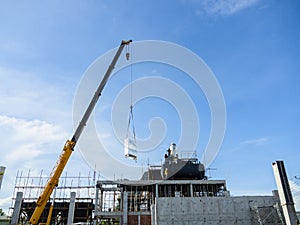 Steel structure work, worker stand on column formwork installing anchor bolt at a construction site.