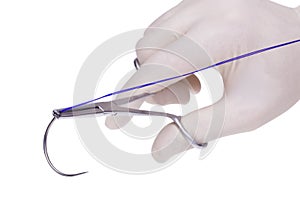 Steel surgical forceps holding a suture needle