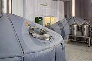 Steel tank for mash fermentation with sight glass in modern brewery.