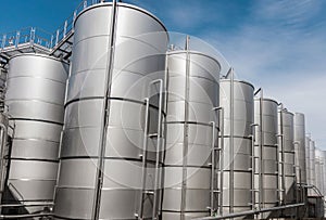 Steel tanks for wine fermentation at a modern winery. Large brewery silos for barley or beer