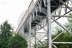 Steel technical design of overhead crossing. industrial footbridge on sky background