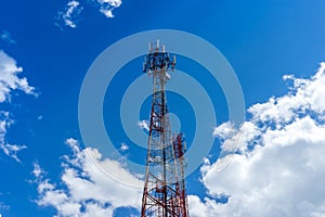 Steel telecommunication tower with antennas over blue sky 1