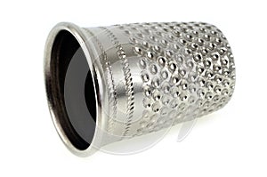 Steel thimble on a white background