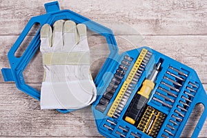 steel toolset and working glove on a wooden table and working glove on a wooden table