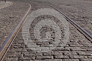 Steel tram tracks in an old cobblestone street