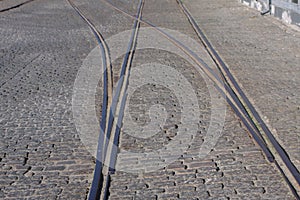 Steel tram tracks in an old cobblestone street