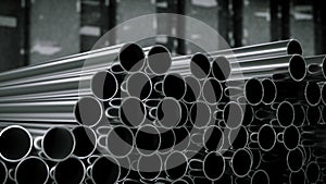 Steel tubes against an industrial blurred factory