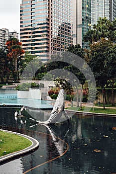 Steel whales sculpture in the park`s pool near Twin Towers in Kuala Lumpur, Malaysia