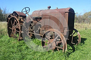 Steel Wheel Rusty Tractor in Tall Grass