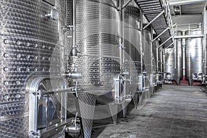 Steel wine tanks for wine fermentation at a winery. modern wine factory with large shine tanks for the fermentation