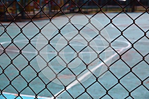 Steel wire net fence with blurred green background