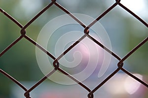 Steel wire net fence with blurred green background