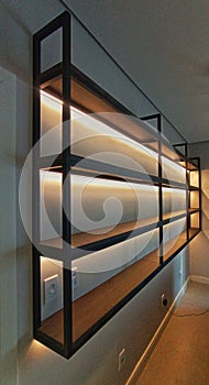 steel and wood shelves with led lighting photo