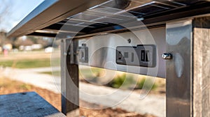 Steelframed solar shade structure featuring closeup of charging outlets with a medium depth of field highlighting