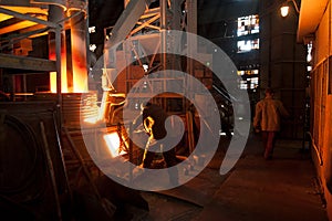 Steelworker near a arc furnace photo