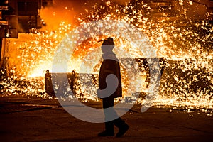 Steelworker near a blast furnace photo