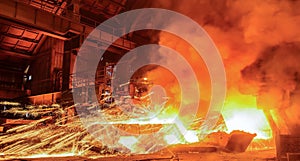 Steelworker near a blast furnace with sparks. Foundry. Heavy industry