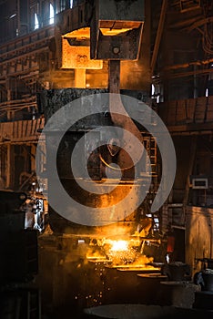Steelworker near the tanks with hot metal photo