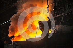 Steelworker near the tanks with hot metal photo