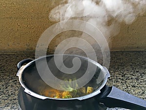 Steeming Stirred fried Broccoli and Sweet Potato in a pan