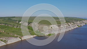 Steep bank of the river from a bird`s eye view. Bank of the Volga River in Russia. Aero 4k
