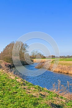 Steep banked river in winter, river Idle West Stockwith Nottinghamshire