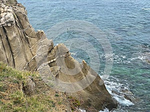 Steep cliffs that descend directly into the sea in Sarti resort, Greece