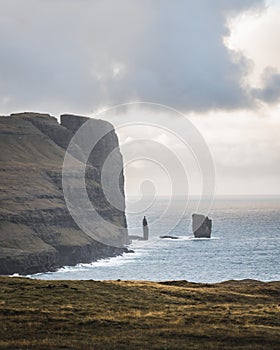 Steep cliffs of Faroe Islands. Vertical cliffs. Massive rocky cliffs, northern landscape