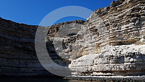 steep cliffs in the sea. the cave is filled with ocean water. beautiful seascape. boat trip near the mountains. summer