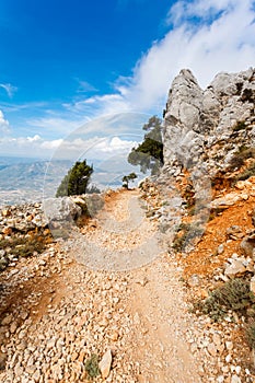 Steep dangerous mountain road with a big gravel in the mountains of Sardinia, Italy